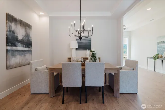 a view of a dining room with furniture wooden floor and chandelier