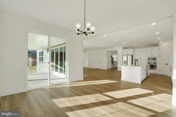 a kitchen with stainless steel appliances a sink and a large window