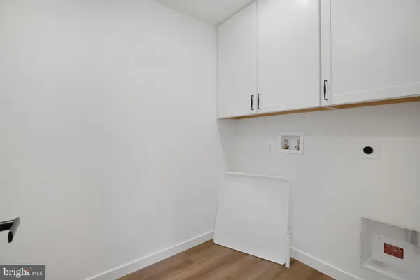 an empty room with windows and cabinet