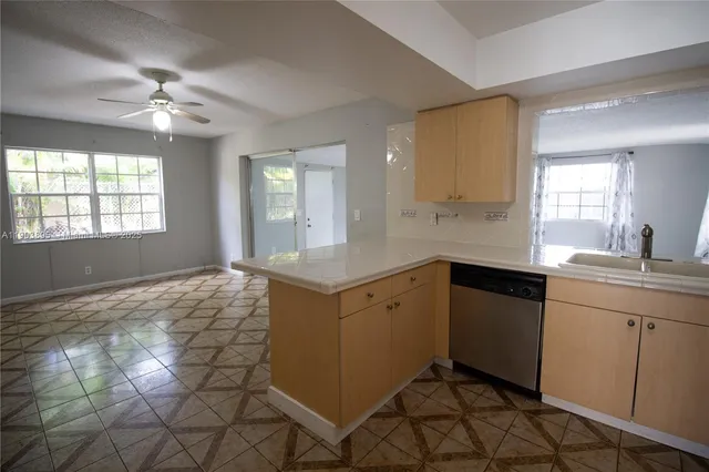a kitchen with a sink cabinets and window