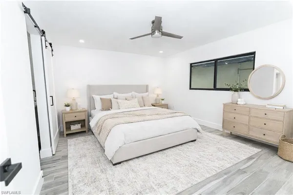 a bedroom with a bed a lamp and a dresser