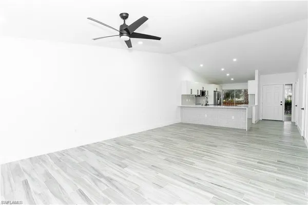 a view of a kitchen with a sink and a refrigerator