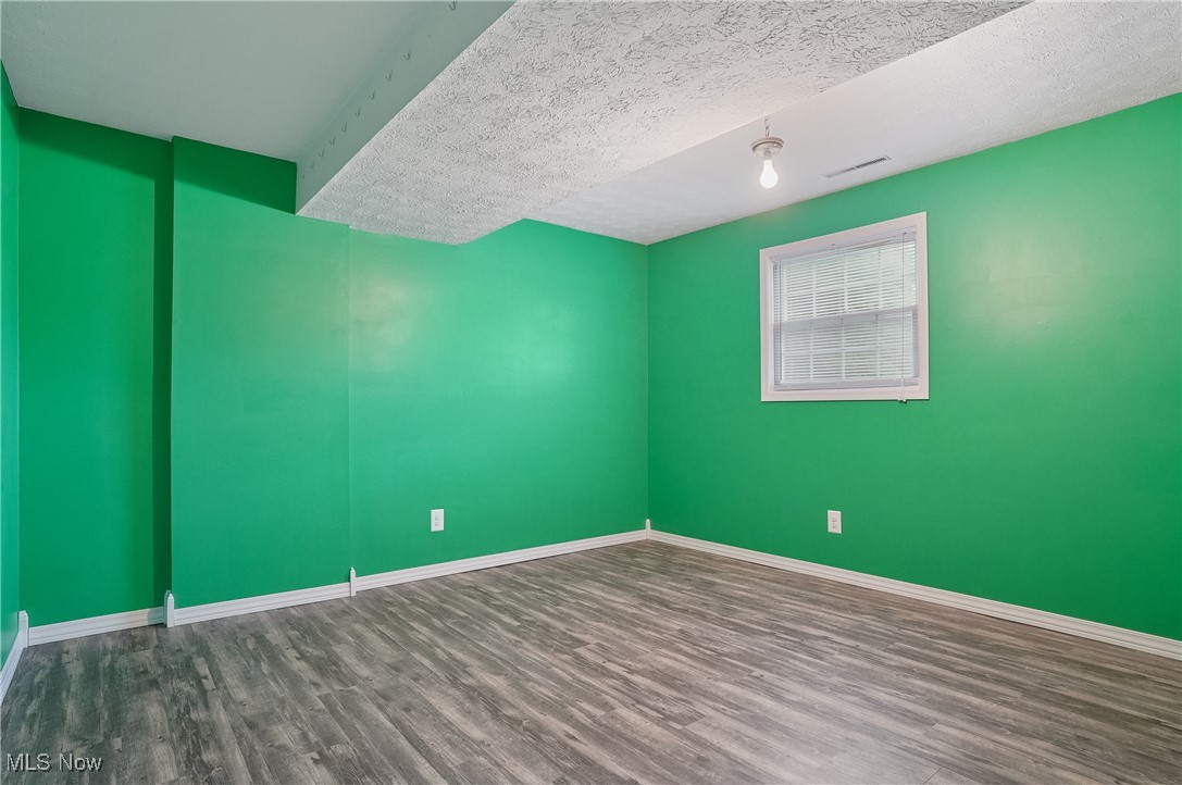 3262 Wright Road Northwest Uniontown, OH 44685 - Photo 30 of 37 Unfurnished room with wood finished floors and a textured ceiling