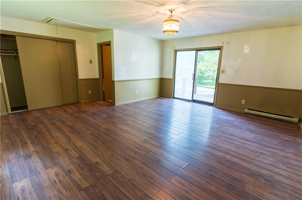 348 South Neshannock Road Hermitage, PA 16148 - Photo 8 of 15 an empty room with wooden floor and windows