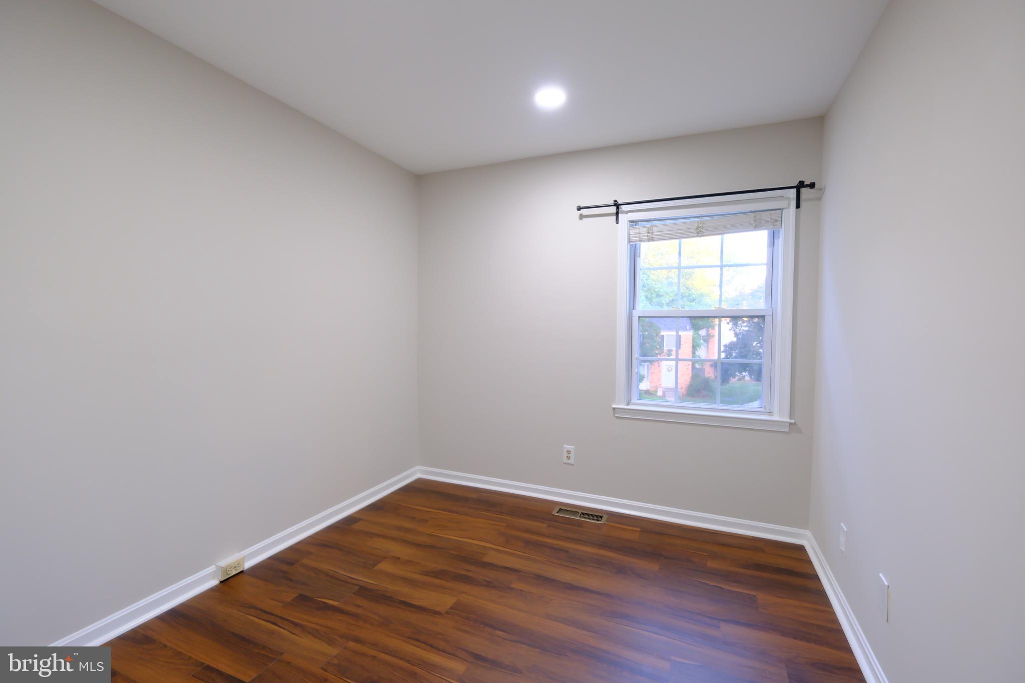 128 Bent Twig Lane, Unit 345 Gaithersburg, MD 20878 - Photo 12 of 17 an empty room with wooden floor and windows