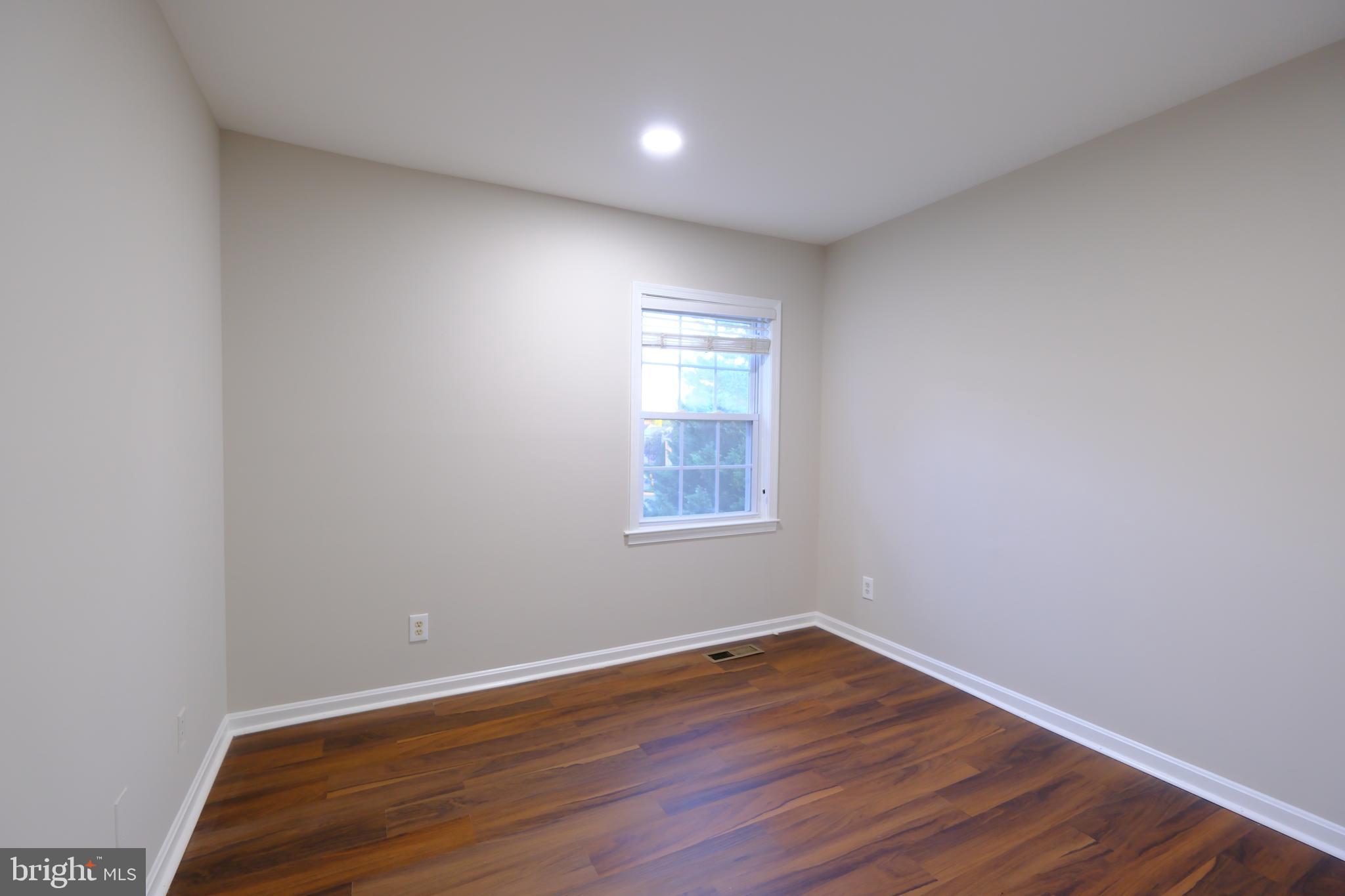 128 Bent Twig Lane, Unit 345 Gaithersburg, MD 20878 - Photo 13 of 17 a view of empty room with wooden floor and fan