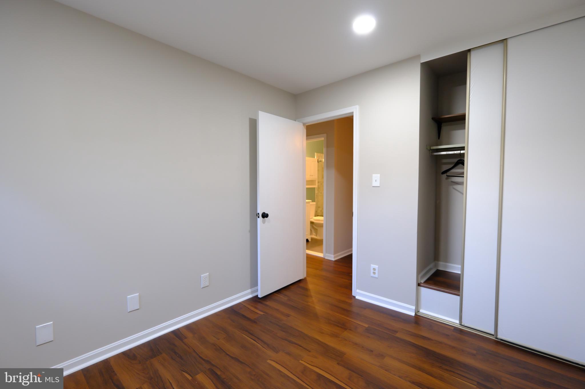 128 Bent Twig Lane, Unit 345 Gaithersburg, MD 20878 - Photo 15 of 17 a view of an empty room with wooden floor and closet