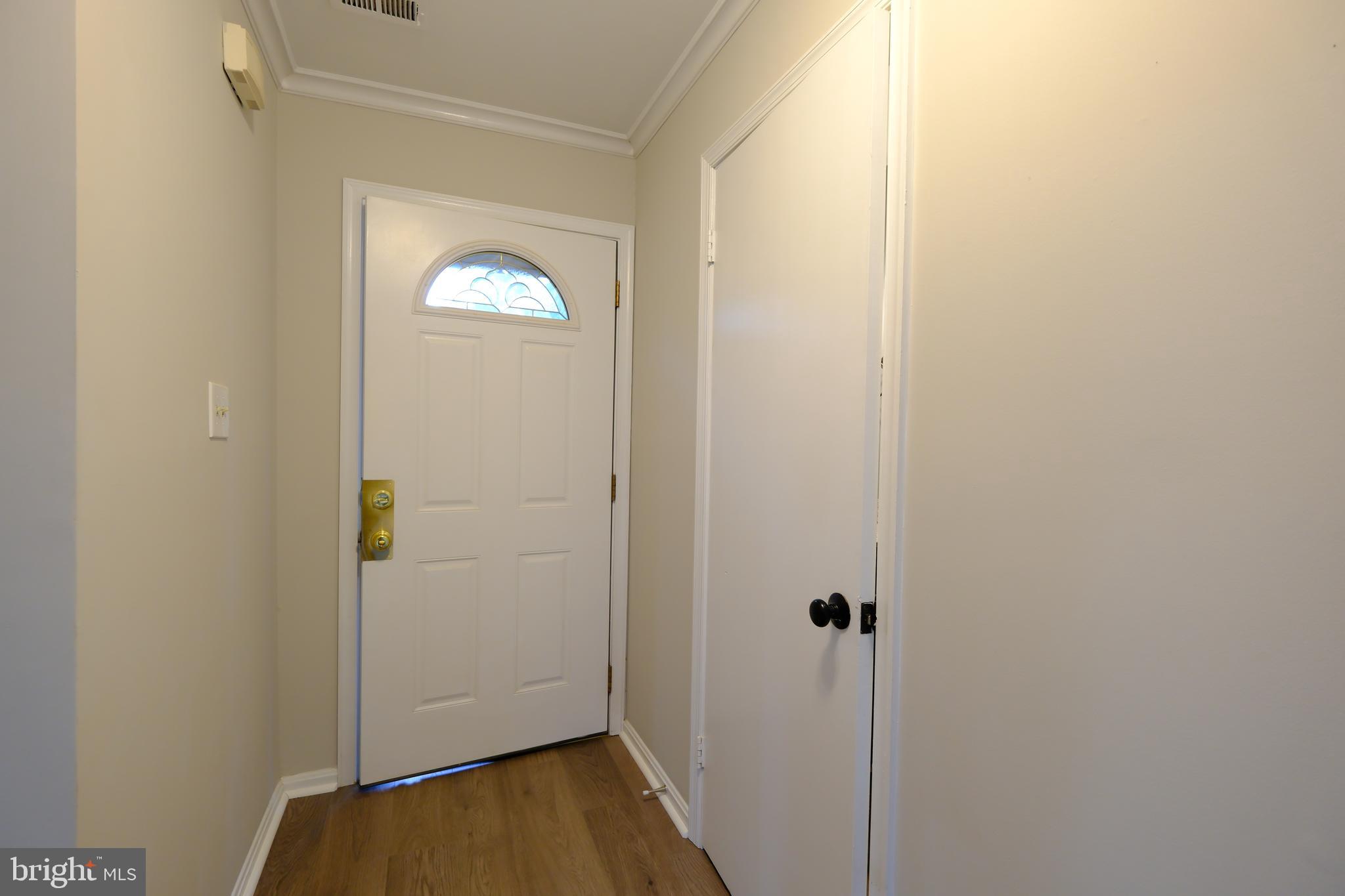 128 Bent Twig Lane, Unit 345 Gaithersburg, MD 20878 - Photo 2 of 17 a view of a hallway with wooden floor