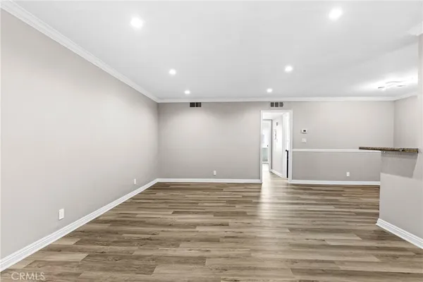 a view of room with wooden floor and fan