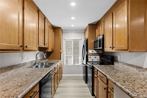 a kitchen with stainless steel appliances a sink stove and cabinets