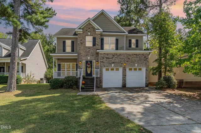 a front view of a house with a yard and garage