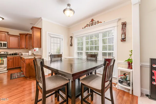 a view of a dining room with furniture and wooden floor
