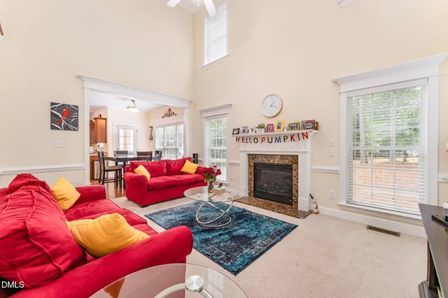 a living room with furniture a fireplace and a window