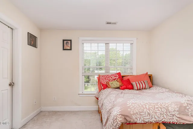 a bedroom with a bed and window