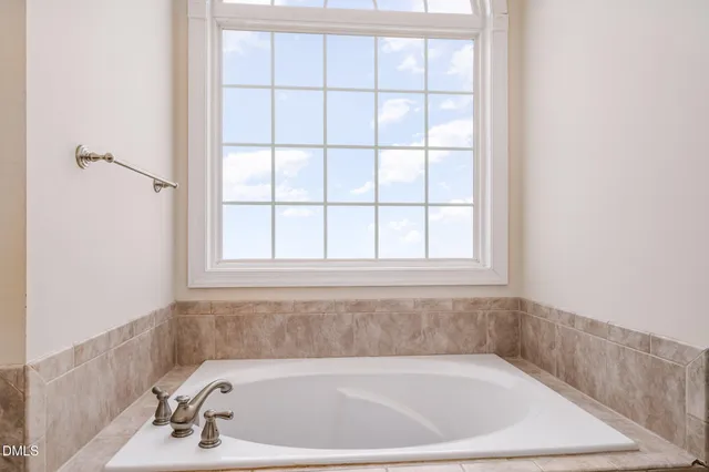 a bath tub sitting next to a window