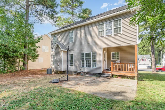 a backyard of a house with yard and outdoor seating