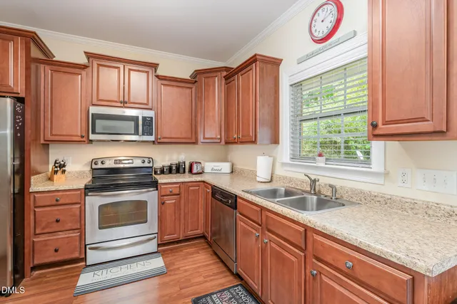 a kitchen with stainless steel appliances granite countertop a sink and a stove