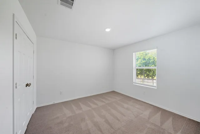 a bedroom with a bed and cabinets