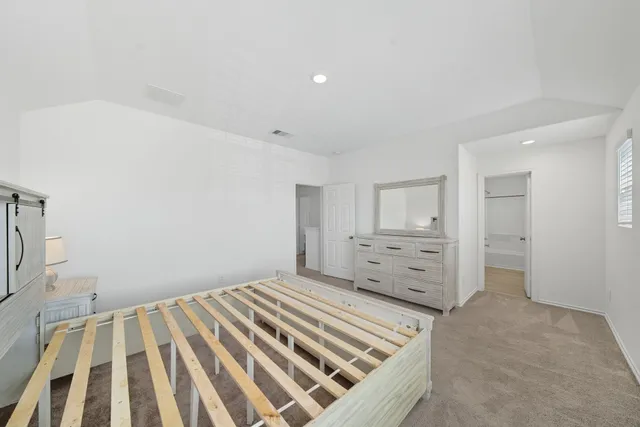 a bedroom with a bed and window