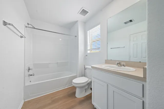 a white toilet sitting next to a shower