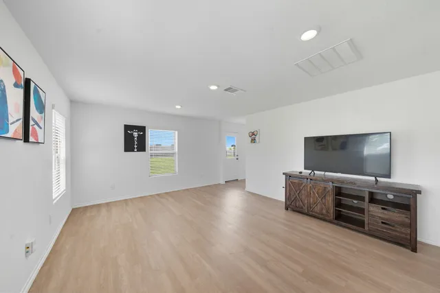 a view of a livingroom with furniture and flat screen tv