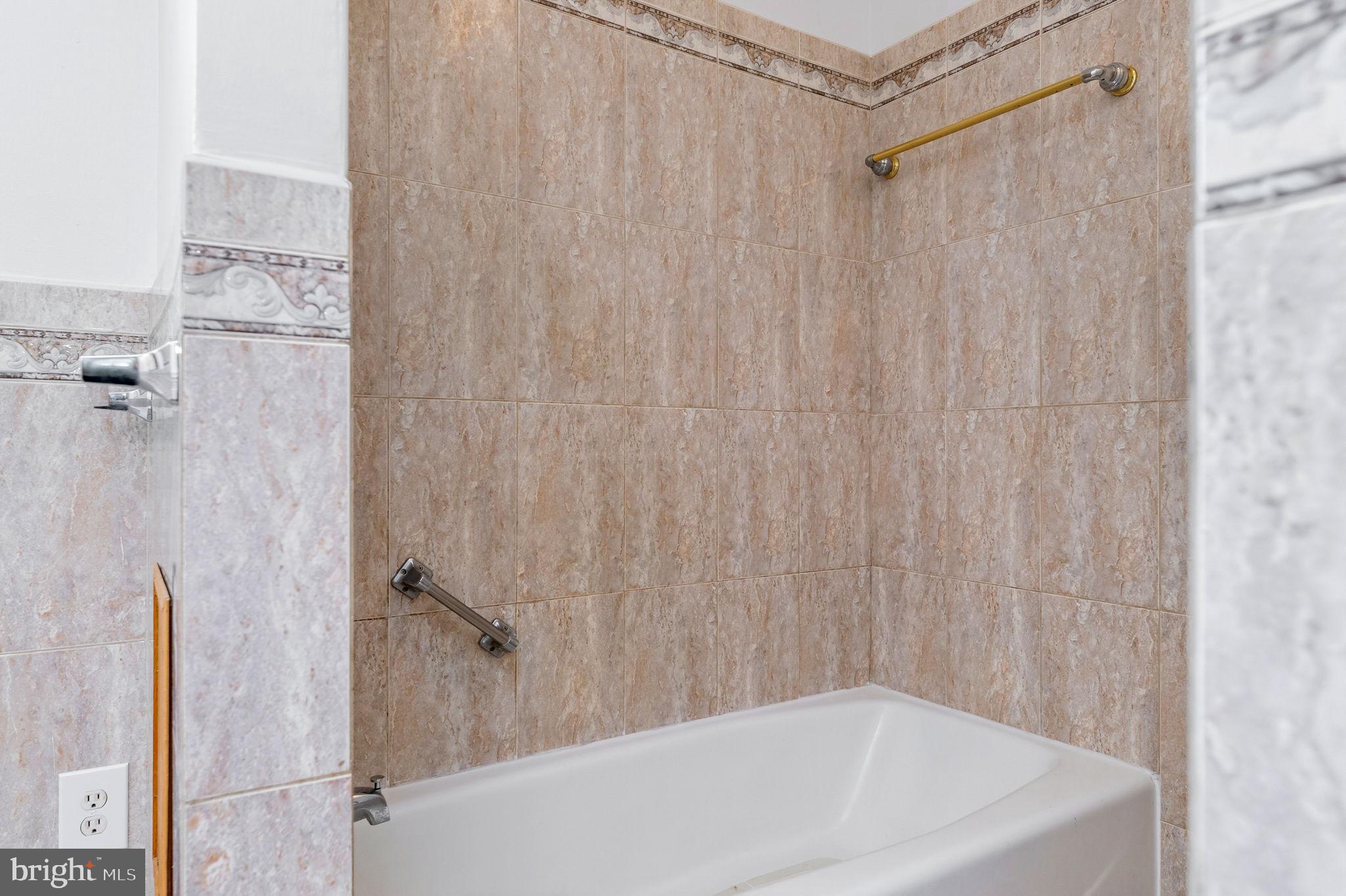 11325 Bacon Race Road Woodbridge, VA 22192 - Photo 24 of 54 a bathroom with a white bath tub and a shower curtain