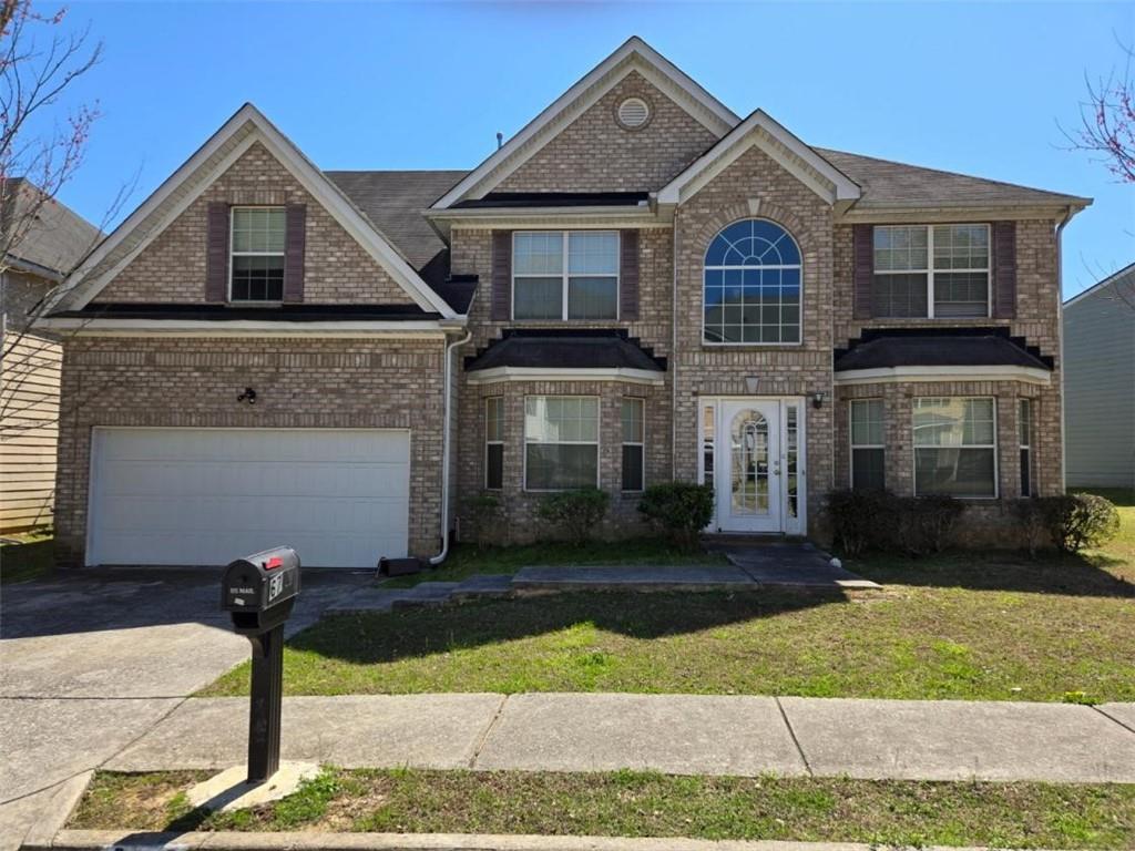 6782 Mancha Street College Park, GA 30349 - Photo 1 of 1 a front view of a house with garden