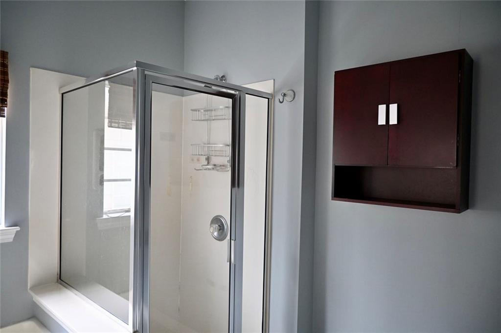 1563 Rachel's Ridge Northwest Kennesaw, GA 30152 - Photo 13 of 29 a bathroom with a shower and a mirror