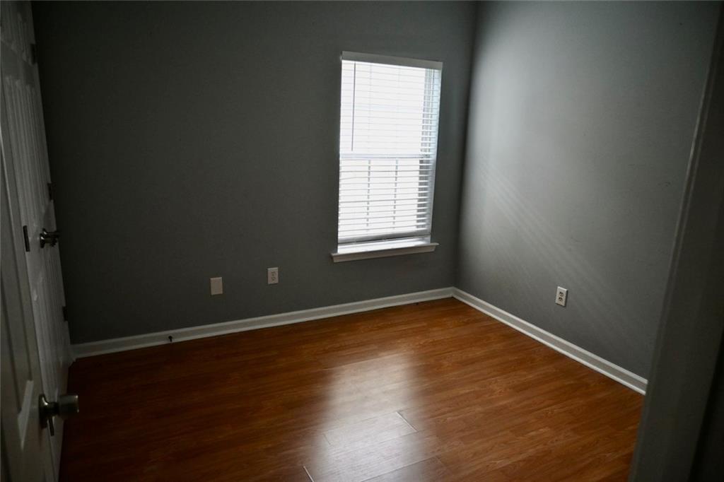 1563 Rachel's Ridge Northwest Kennesaw, GA 30152 - Photo 16 of 29 an empty room with wooden floor and windows