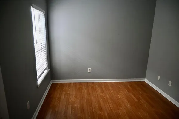 a view of a room with wooden floor and window