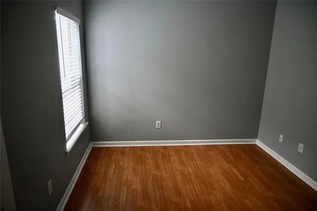 a view of a room with wooden floor and window