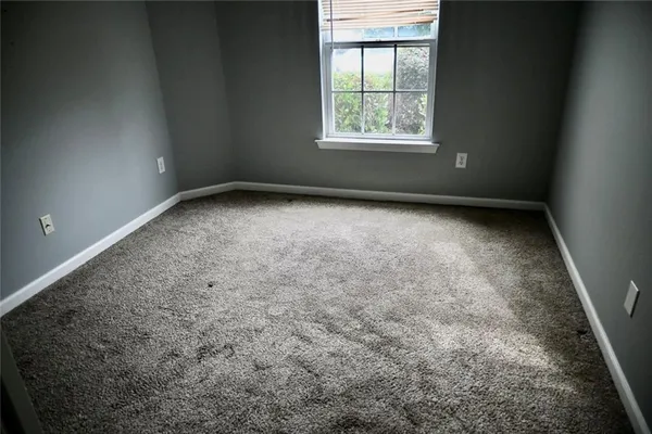 an empty room with a empty space and windows