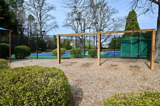 a view of a house with backyard and trees