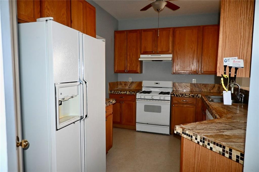 1563 Rachel's Ridge Northwest Kennesaw, GA 30152 - Photo 9 of 29 a kitchen with a stove a refrigerator and a sink