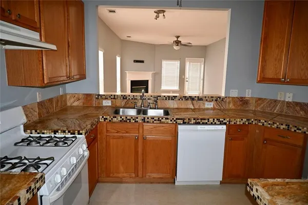 a kitchen with a stove and a refrigerator