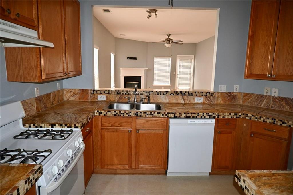 1563 Rachel's Ridge Northwest Kennesaw, GA 30152 - Photo 10 of 29 a kitchen with a stove and a refrigerator