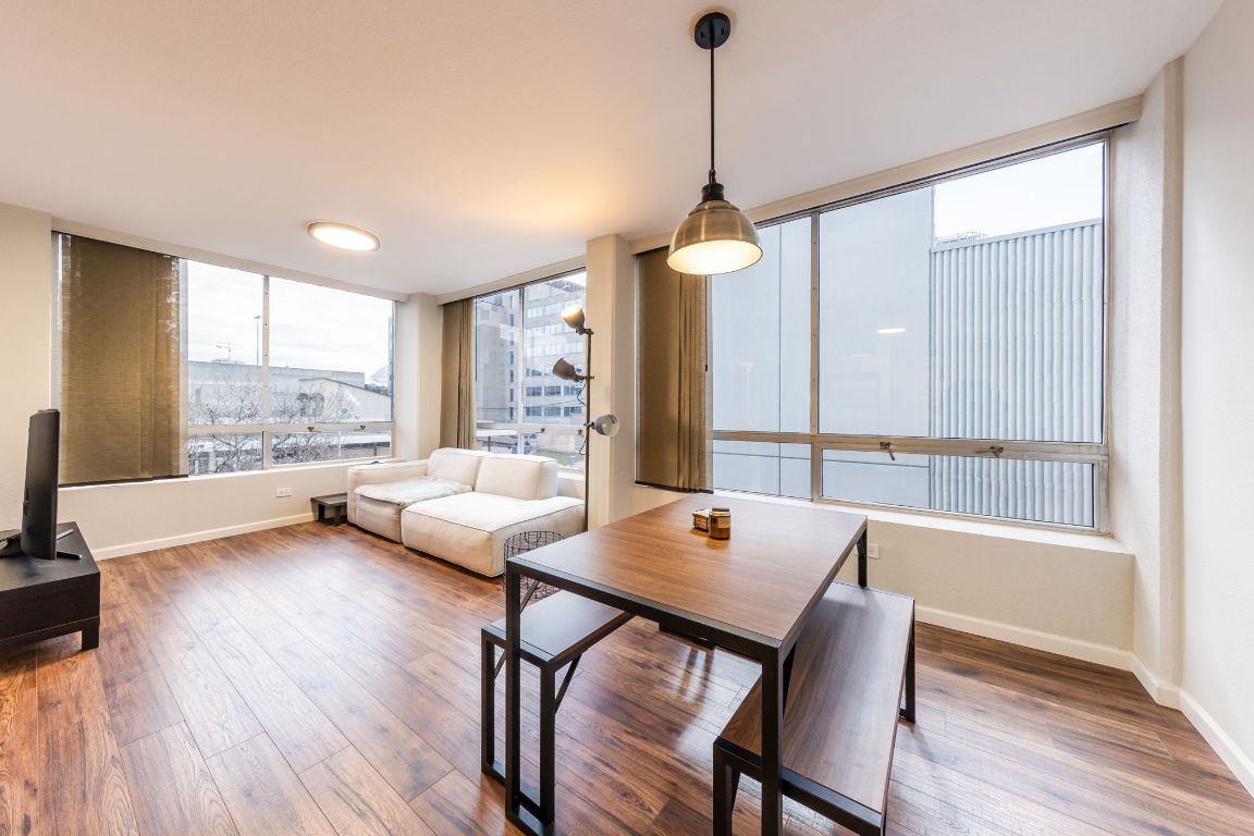 1212 Guadalupe Street, Unit 301 Austin, TX 78701 - Photo 1 of 28 a view of a dining room with furniture window and wooden floor