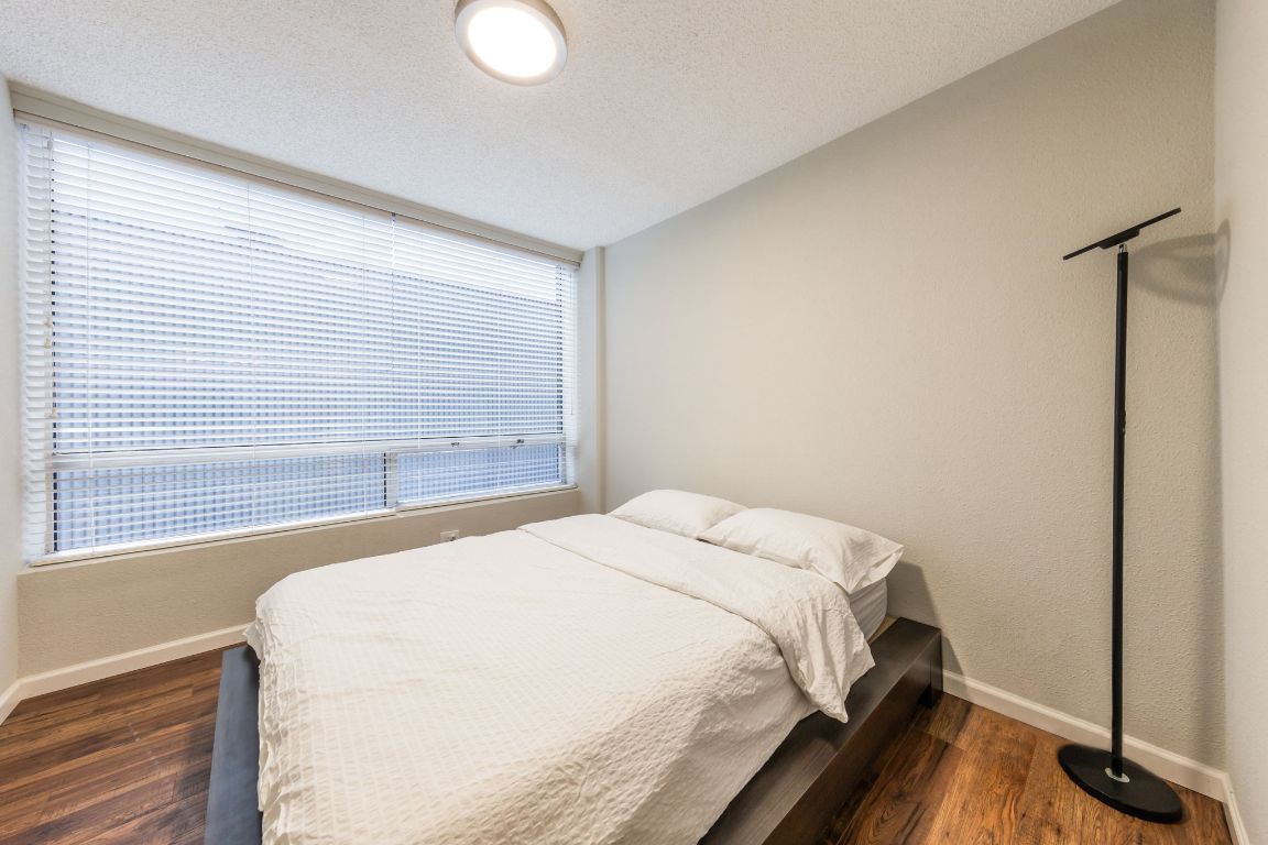 1212 Guadalupe Street, Unit 301 Austin, TX 78701 - Photo 12 of 28 a bedroom with a bed and a window
