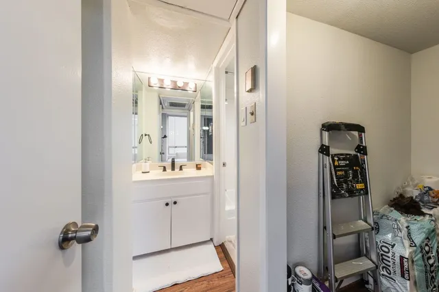 a bathroom with a shower sink and mirror