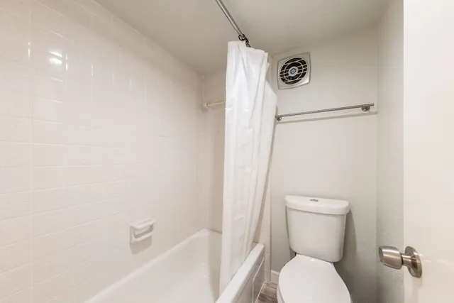 a bathroom with a toilet a sink and a bathtub