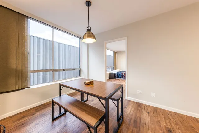 a view of a dining room with furniture window and wooden floor