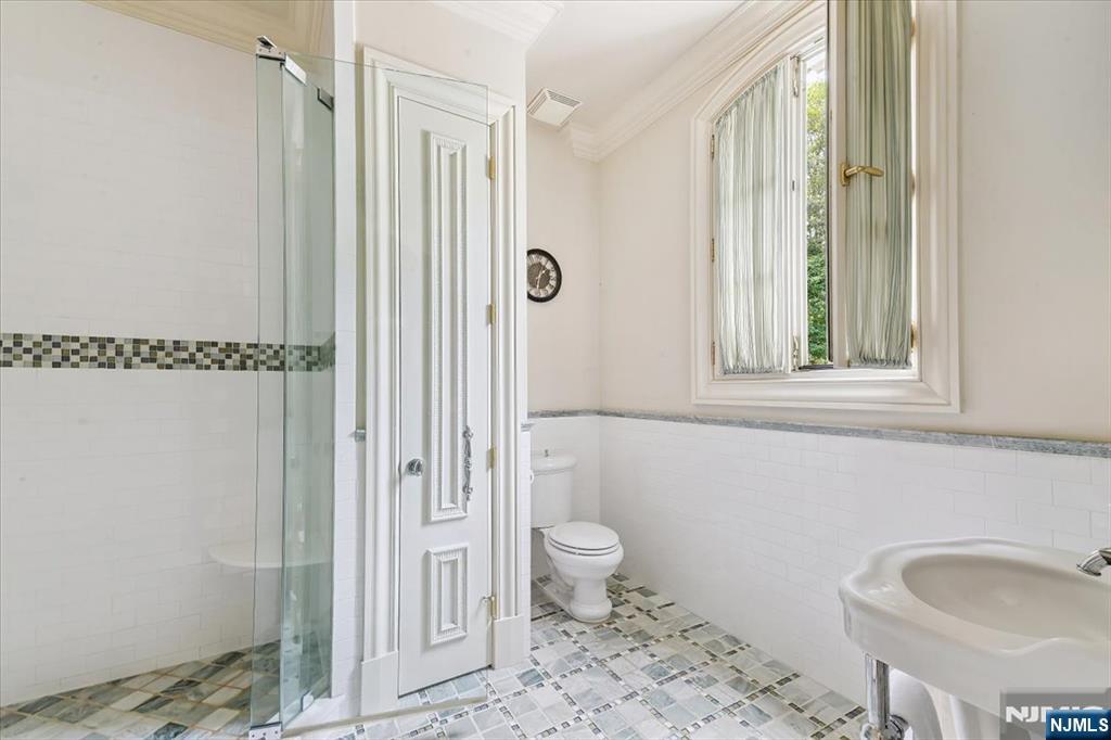 47 Fox Hedge Road Saddle River, NJ 07458 - Photo 17 of 22 a bathroom with a sink a toilet and shower