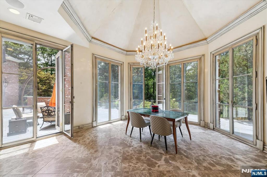 47 Fox Hedge Road Saddle River, NJ 07458 - Photo 8 of 22 a dining room with furniture a chandelier and glass door