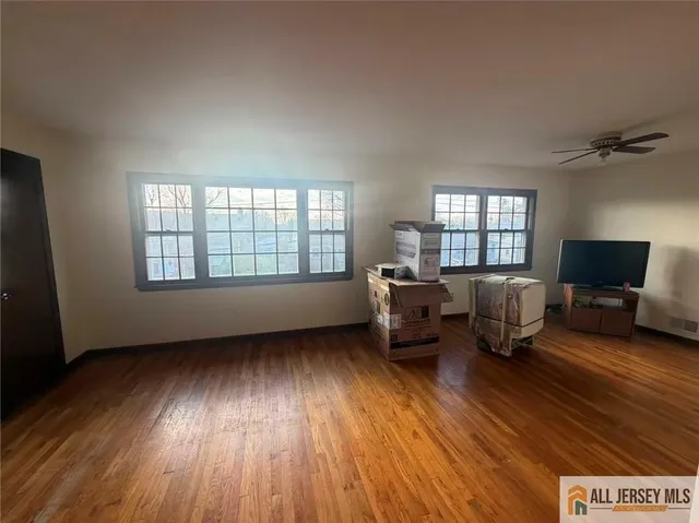 a kitchen with wooden floors a stove and a refrigerator