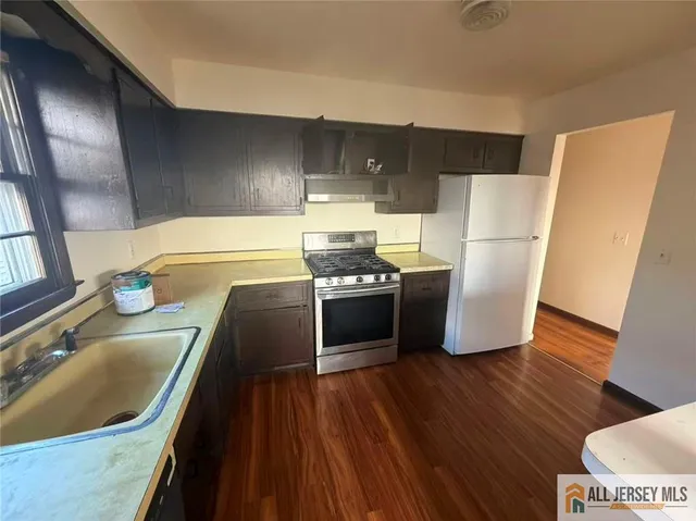 a view of a hallway view with wooden floor and staircase