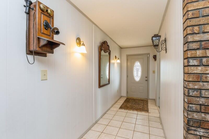 6246 Holloway Road Baker, FL 32531 - Photo 13 of 52 a view of a hallway with wooden floor and windows