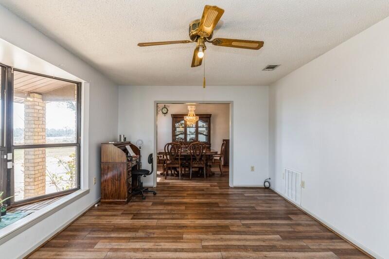 6246 Holloway Road Baker, FL 32531 - Photo 14 of 52 a view of empty room with wooden floor and fan
