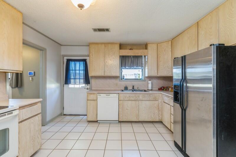 6246 Holloway Road Baker, FL 32531 - Photo 18 of 52 a kitchen with a refrigerator sink and cabinets