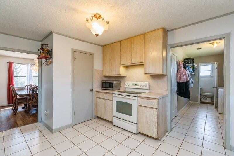 6246 Holloway Road Baker, FL 32531 - Photo 20 of 52 a kitchen with a stove sink and cabinets