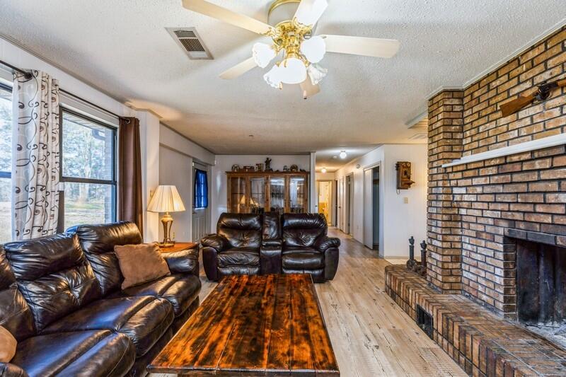 6246 Holloway Road Baker, FL 32531 - Photo 22 of 52 a living room with furniture a fireplace and a large window
